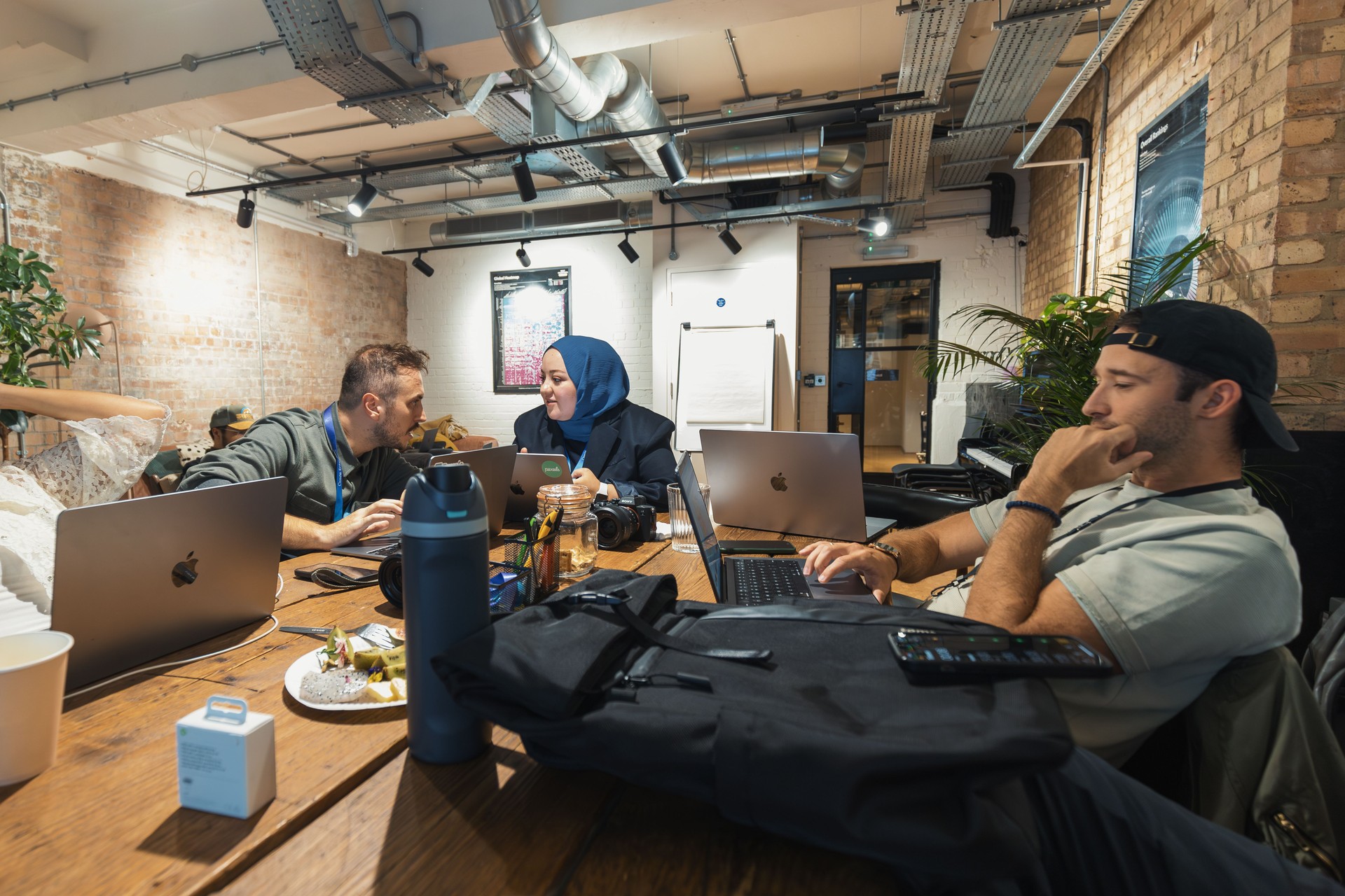 Diverse team collaborating with laptops in a modern office