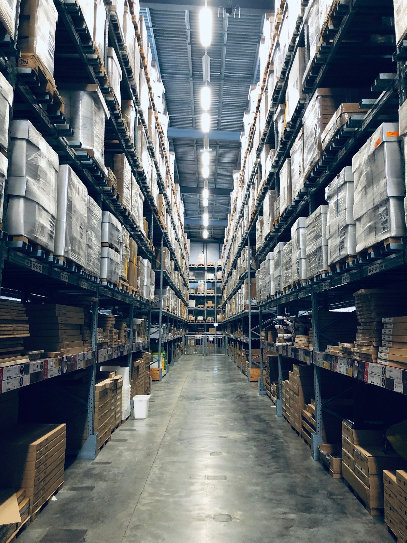 Aisle of stocked racking inside a distribution warehouse